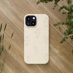 May include: A beige phone case with a floral pattern. The case has a raised camera bump with three black lenses.