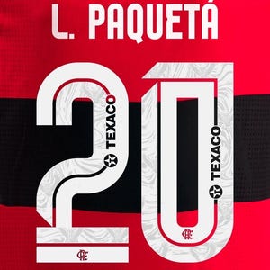 May include: Red and black jersey with the name "L. Paquet&aacute;" in white block letters above the number "20". The number is white with a patterned design and the Texaco logo.