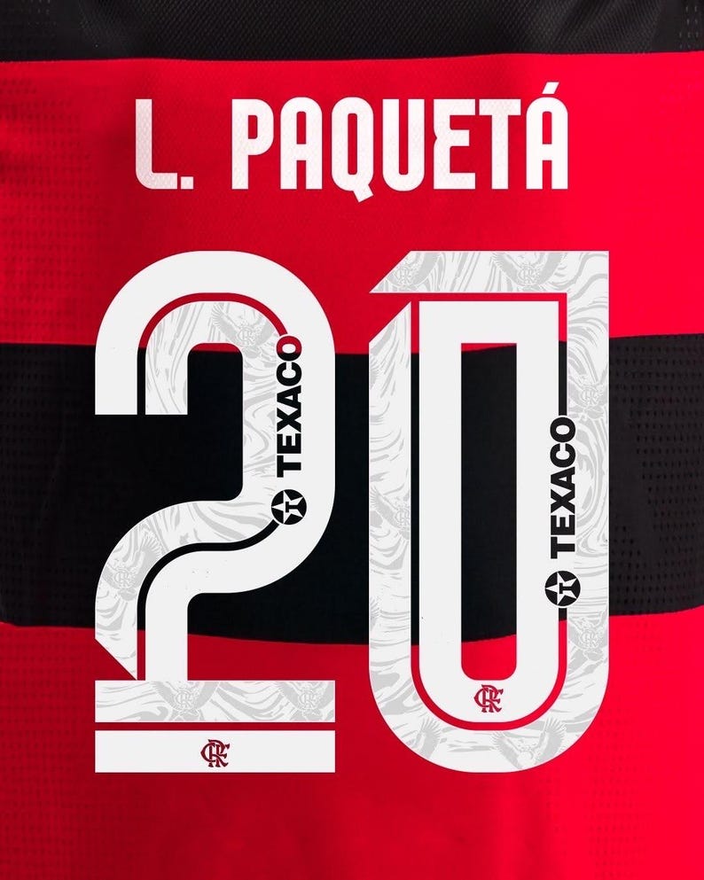 May include: Red and black jersey with the name "L. Paquet&aacute;" in white block letters above the number "20". The number is white with a patterned design and the Texaco logo.