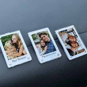 May include: Three clear acrylic photo frames with white borders. Each frame contains a photograph and a printed phrase: "Best Forever" and "My forever love". The photos show people and a dog.