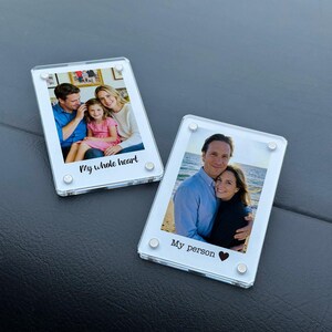 May include: Two clear acrylic photo frames with family photos. One frame has the text "My whole heart" and the other says "My person" with a heart symbol. Each frame is held together with four silver-colored screws.