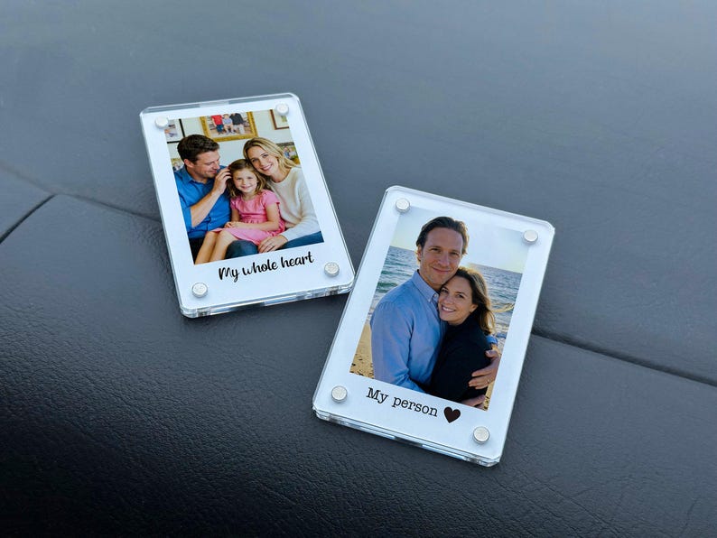 May include: Two clear acrylic photo frames with family photos. One frame has the text "My whole heart" and the other says "My person" with a heart symbol. Each frame is held together with four silver-colored screws.