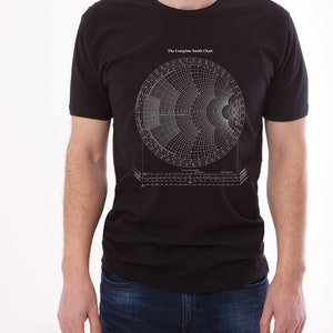 May include: A black t-shirt with a white graphic of a Smith Chart, a tool used in electrical engineering to visualize impedance matching. The text "The Complete Smith Chart" is printed above the chart.