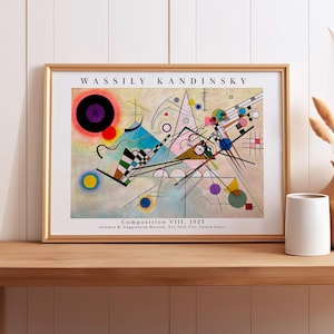 May include: A framed art print of Wassily Kandinsky's Composition VIII, 1923. The print features a beige background with geometric shapes, including black circles, triangles, and intersecting lines in various colors like blue, red, and green.