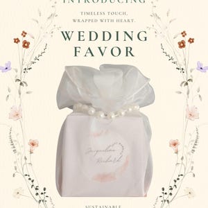 May include: A wedding favor wrapped in white fabric and tied with a pearl necklace. The package is adorned with a floral design and the words "Wedding Favor." Text on the package reads "Jacqueline Richard."