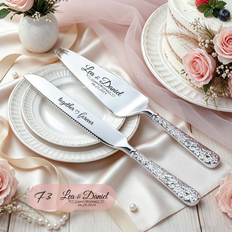 May include: A silver cake knife and server set with ornate textured handles. The knife is engraved with the text together forever and the server features the names Lea & Daniel with the date 06.24.2024. The metal blades have a polished finish.
