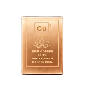 May include: A rectangular copper bar with the element symbol "Cu" and the text "FINE COPPER 99.9% ONE KILOGRAM MADE IN INDIA". The bar features a lotus flower design and is a rich, warm copper color.