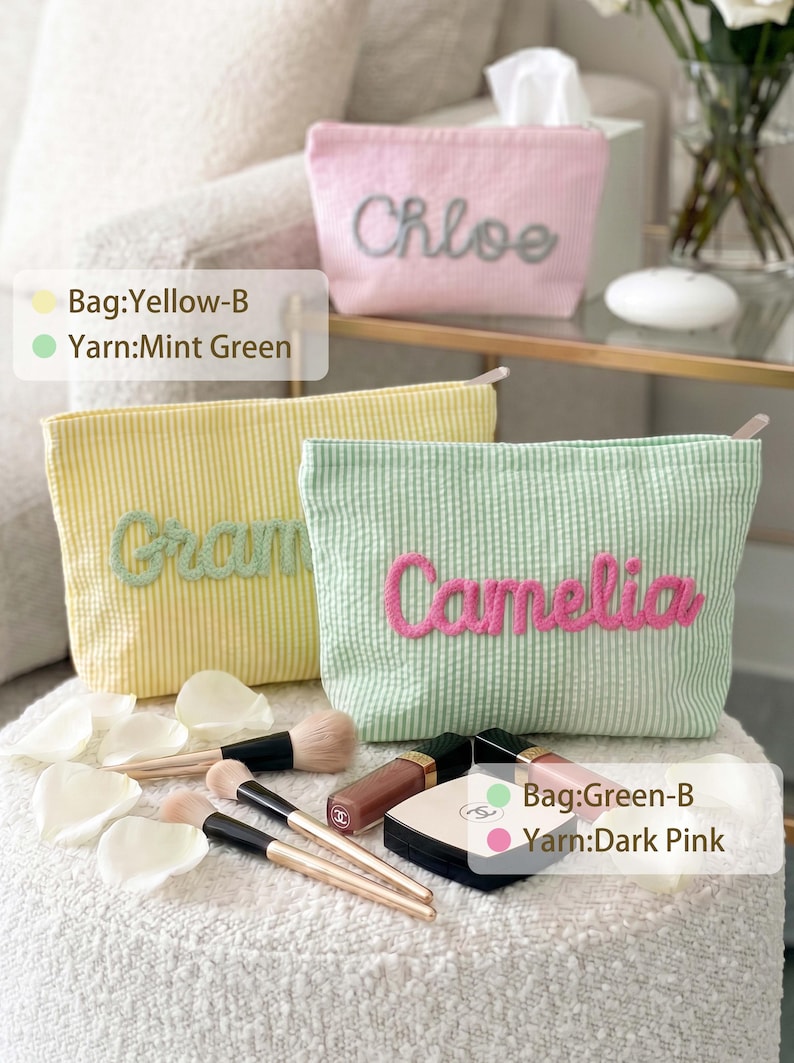 May include: Three seersucker zipper pouches in pink, yellow, and mint green. The pink pouch features the name Chloe in grey, the yellow pouch has the name Gram in mint green, and the mint green pouch displays the name Camelia in dark pink.