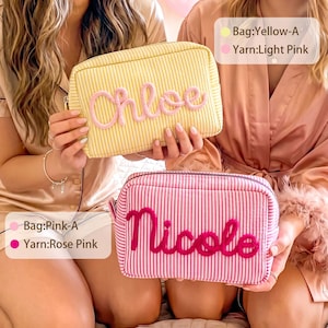 May include: Two rectangular zippered pouches with vertical stripes. The yellow pouch features the name Chloe in light pink yarn, while the pink pouch displays the name Nicole in rose pink yarn. Text labels indicate Bag:Yellow-A, Yarn:Light Pink, Bag:Pink-A, and Yarn:Rose Pink.