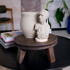 May include: A rustic wooden sign with the text "Welcome to our home" in white lettering. The sign features a distressed finish and a simple, inviting design, perfect for a front porch or entryway.