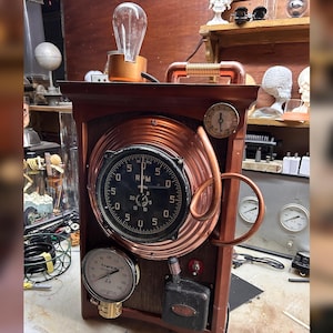 May include: A steampunk-style wooden box with copper accents and gauges. The box features a large RPM gauge, a smaller pressure gauge, and a decorative copper coil. An Edison-style light bulb sits atop the box, adding to the vintage aesthetic.