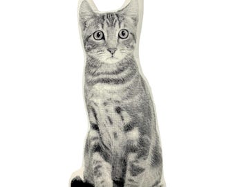May include: A gray and white cat pillow with a realistic design. The cat is sitting upright with its ears perked up and its eyes open.