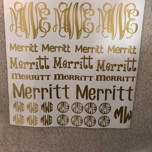 May include: A sheet of gold vinyl lettering with the name "Merritt" written in various sizes and styles. The sheet also includes several gold vinyl circles with the monogram "MW" in them.