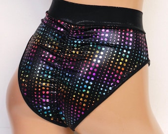May include: High-waisted shorts featuring a black fabric base with a reflective, multi-colored dot pattern. The shorts include a wide, solid black waistband and a gathered, ruched seam detail running vertically down the center back panel.