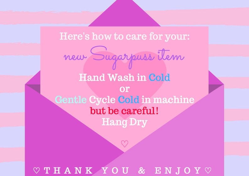 May include: Pink envelope with a handwritten note inside. The note says "Here's how to care for your: new Sugarpuss item Hand Wash in Cold or Gentle Cycle Cold in machine but be careful! Hang Dry THANK YOU & ENJOY"