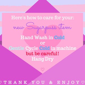 May include: Pink and white striped background with a pink envelope. The envelope has a pink card inside with the text "Here's how to care for your: new Sugarpuss item Hand Wash in Cold or Gentle Cycle Cold in machine but be careful! Hang Dry THANK YOU & ENJOY♡".