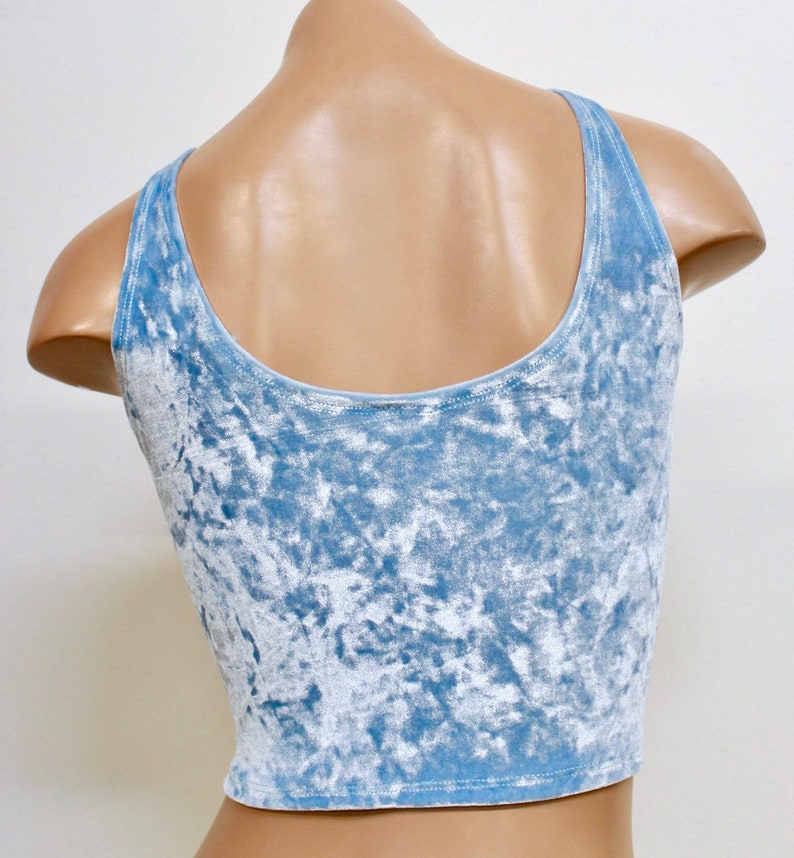 May include: A light blue crushed velvet tank top with a scoop neck and thin straps.
