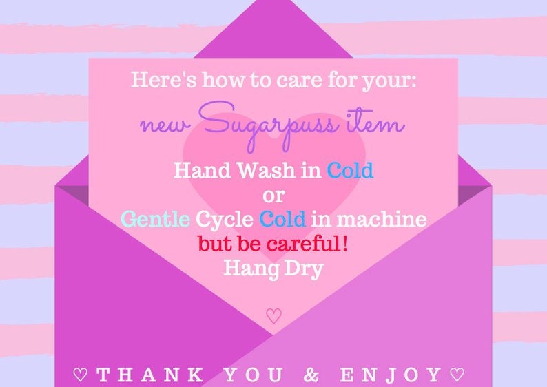May include: Pink envelope with a handwritten note inside. The note says "Here's how to care for your: new Sugarpuss item Hand Wash in Cold or Gentle Cycle Cold in machine but be careful! Hang Dry THANK YOU & ENJOY"