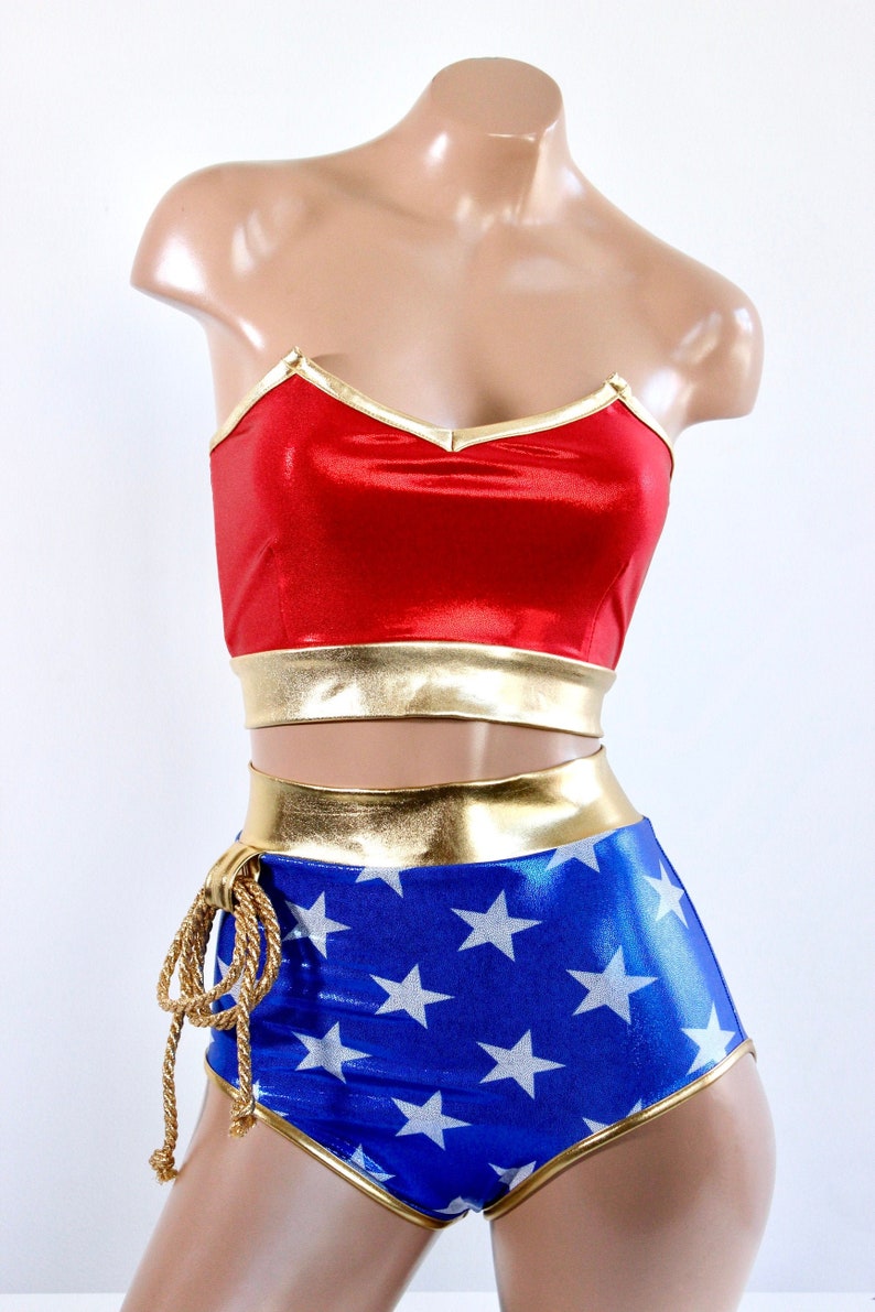 May include: A red and blue costume with gold trim and white stars. The costume has a strapless top and high-waisted shorts. The shorts have a rope tie at the side.