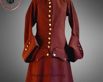 May include: A burgundy long-sleeved coat with gold buttons. The coat has a stand-up collar and a single-breasted closure. The coat has a fitted waist and a flared skirt. The coat is made of a thick, textured fabric. The coat is labeled "Regency Clothing".