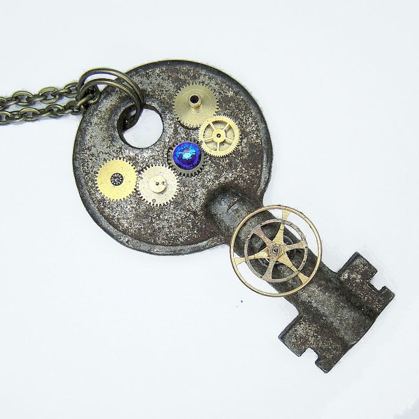 Tardis Key Necklace - comprised of gold bronze and brass gears with a deep blue crystal rhinestone - Post Apocalyptic Style jewelry