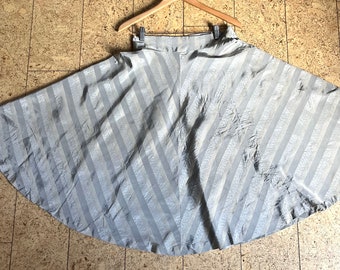 May include: A silver and white striped skirt with a full, flowing silhouette. The skirt has a high waist and a gathered design.