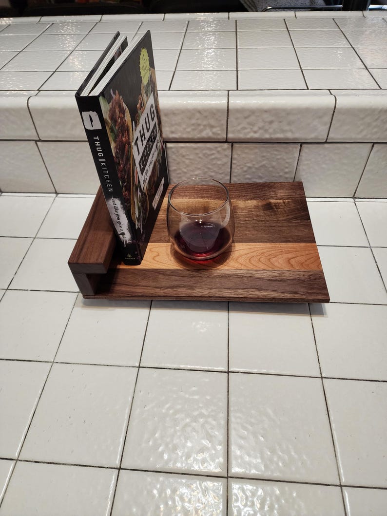 May include: A wooden serving tray with a cookbook titled "Thug Kitchen: Eat Like You Give a Damn" and a glass of red wine. The tray is made of walnut wood and has a natural finish.