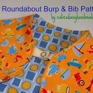 May include: A yellow fabric bib with a blue and white geometric pattern on the back. The front of the bib features a repeating pattern of toy vehicles, including airplanes, cars, trucks, and boats. The text "The Roundabout Burp & Bib Pattern by calicodaisyhandmade.com" is printed at the top of the image.