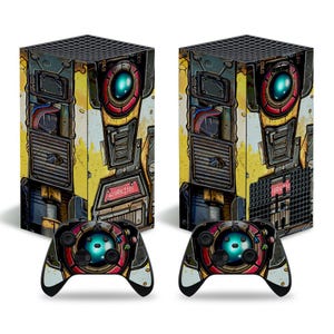 Könnte beinhalten: Zwei Spielkonsolen und zwei passende Controller. Die Konsolen und Controller haben ein gelbes, rotes und graues Design mit einem roboterartigen Gesicht. Das Wort "WARNING" ist auf der Konsole sichtbar.