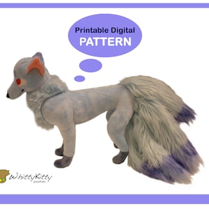 May include: Printable digital pattern for a plush toy fox with a blue and purple fluffy tail. The fox has red eyes and a light blue body. The text "Printable Digital PATTERN" is in a thought bubble above the fox.