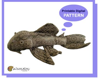 May include: Printable digital sewing pattern for a brown and gray plush toy fish with a textured, scaly design. The pattern is for a fish with a large head and a long, thin tail. The pattern is called "Printable Digital PATTERN".