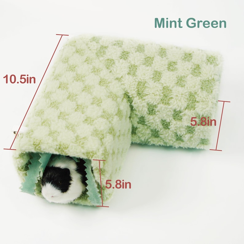 May include: A mint green pet tunnel, 10.5 inches long and 5.8 inches wide, with a checkered pattern. The tunnel is made of soft, plush material. A small pet with black and white fur is inside the tunnel. The text "Mint Green" is visible.