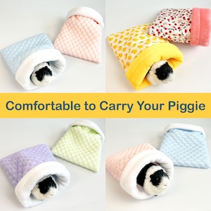 May include: A collection of small, quilted pet pouches in various colors, including blue, pink, yellow, and purple. Each pouch has a soft, white interior and is designed to comfortably house a small pet, such as a guinea pig. The text "Comfortable to Carry Your Piggie" is displayed.