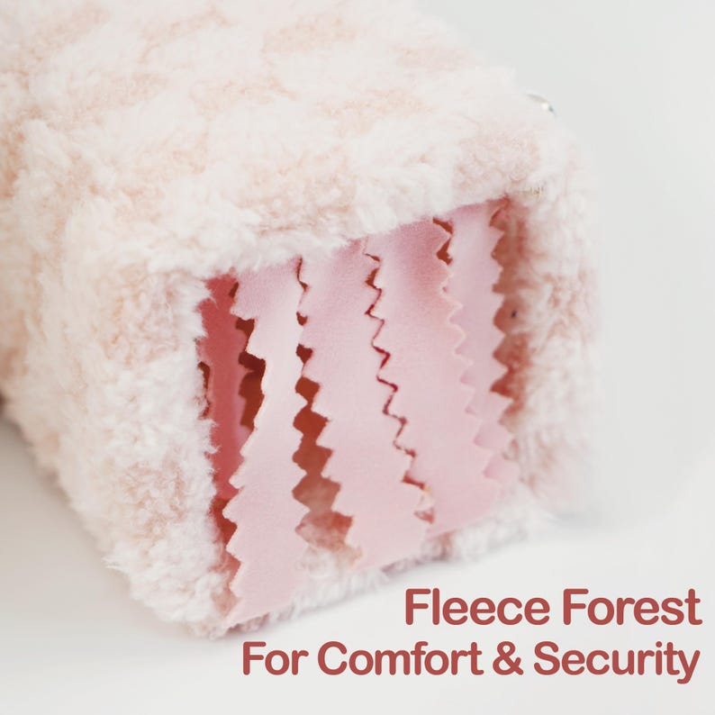 May include: A close-up of a soft, plush, pink and white fleece item. The item has a textured exterior and a pink, zig-zag cut interior. The text "Fleece Forest For Comfort & Security" is visible in the bottom right corner.
