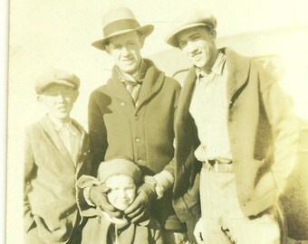 1920s papá sosteniendo niños cabeza para mirar cámara familia hombres hermanos niños 20s Vintage fotografía negro blanco Sepia foto