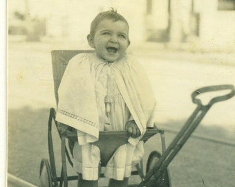 Happy Laughing Baby Standing in Stroller Cape Street Car Track Road Antique Photo Black White Photograph