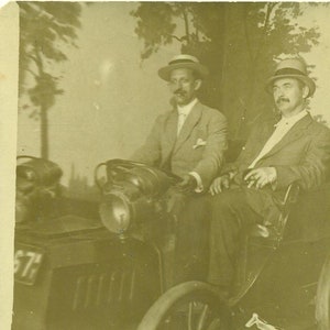 Two Men Sitting in a Car Driving Novelty Tourist Photo 1910s RPPC Real Photo Postcard Antique Photograph Black White Photo