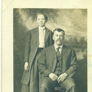Martin E Coons and WifeSitting Man Woman Jacket 1910s RPPC Real Photo Postcard Antique Photograph Black White Photo