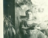 Woman Reading Book Inside Wallpaper Room Mantle Clock Wicker Chair 1910s Antique RPPC Real Photo Postcard Photograph Black White Photo