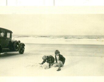 1920s Ford Car Parked on Beach Kids Playing in Sand Ocean Vintage Black White Photo Photograph