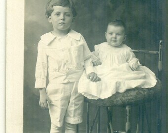 I'd Rather Be Playing Solemn Boy With Baby Studio Portrait Antique RPPC Real Photo Postcard