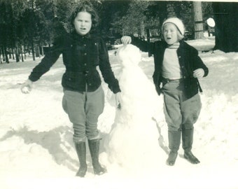 1930s Girls Building A Snowman Winter Snow Snowball in Hand Vintage Black White Photo Photograph