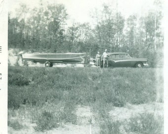 Happy Campers Chevy Pulling Fishing Boat Older Couple Standing by Lake 1957 Vintage Black and White Photo Photograph