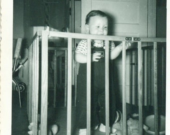 1950s Baby Boy Standing in Play Pen Fence Gate Toys Toddler 50s Vintage Photograph Black White Photo