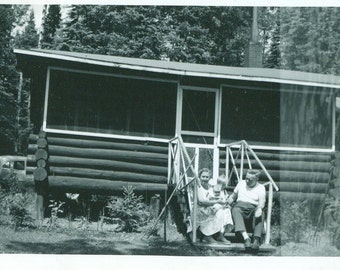 Grandparents Holding New Baby Front Steps of Little Log Cabin Cottage Vintage 1950s Black and White Photo Photograph
