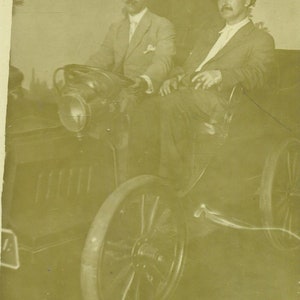 Two Men Sitting in a Car Driving Novelty Tourist Photo 1910s RPPC Real Photo Postcard Antique Photograph Black White Photo