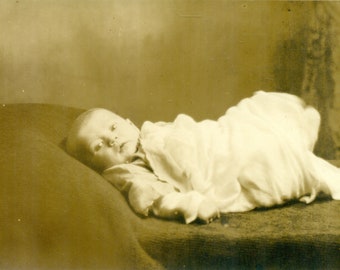 Tiny Baby Swaddled in Blanket Laying on Bed Intent Look RPPC Real Photo Postcard Photograph
