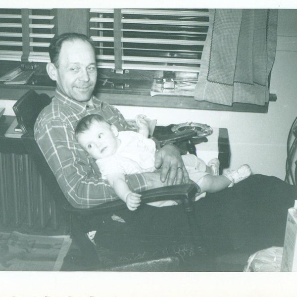 1940s Tired Dad Holding Baby Rocking Chair Milk Carton Telephone Table 40s Vintage Photograph Black White Photo