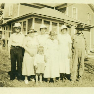 Farm Family Photo Man in Coveralls Women in Best Hats Standing in Front of House 1920s Black and White Vintage Photo Photograph