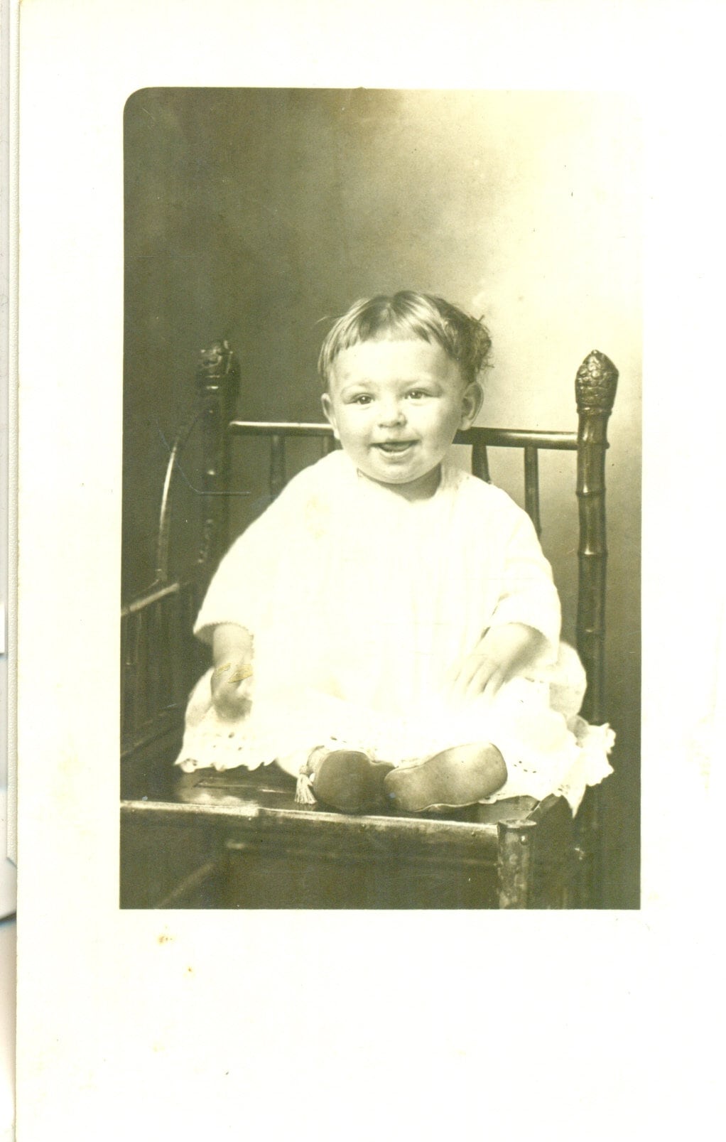 Little Tongue Smile Baby Sitting in Chair Portrait Antique RPPC Real Photo Postcard Vintage Photograph